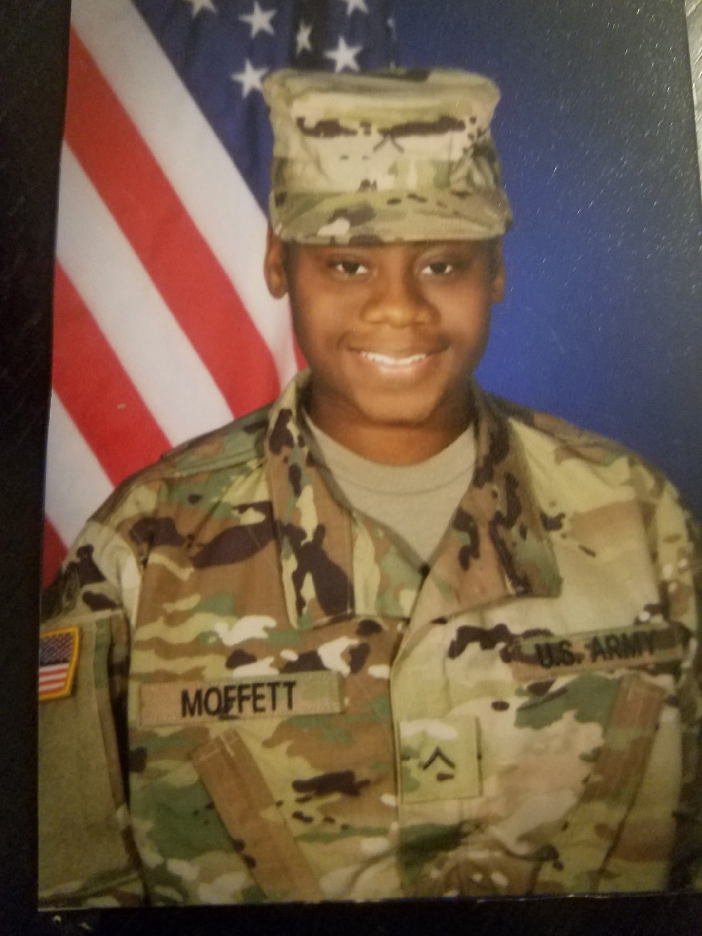 Sgt. Breonna Moffett in service uniform with U.S. flag