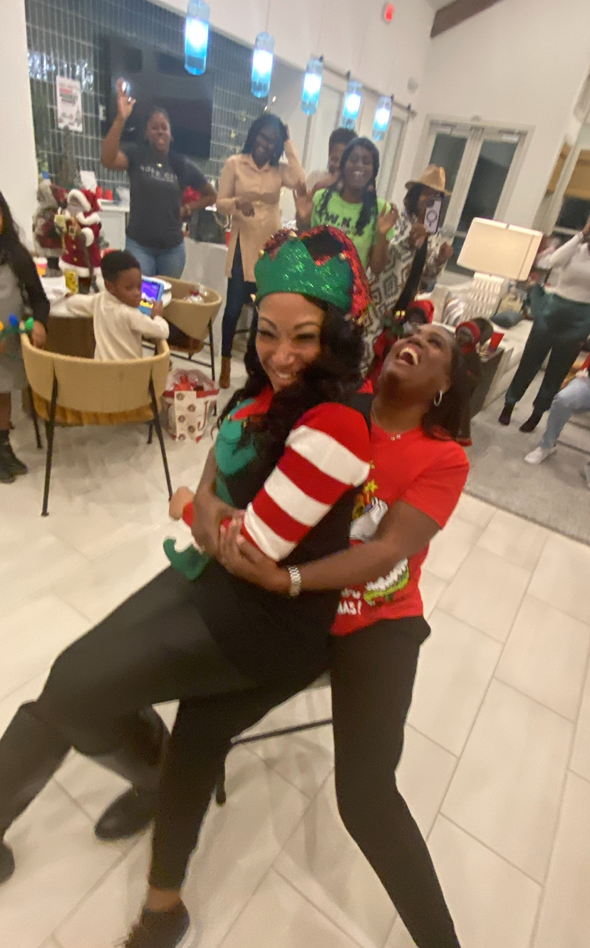Holiday gathering — members laughing together in festive elf attire