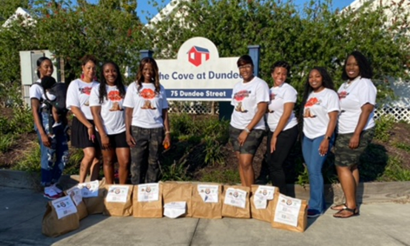 Members at The Cove at Dundee with bagged donations for a community drive