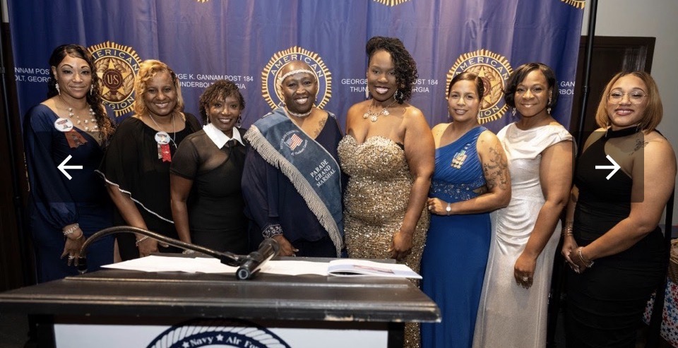 Members posing with the Parade Grand Marshal at the American Legion Post 184 gala