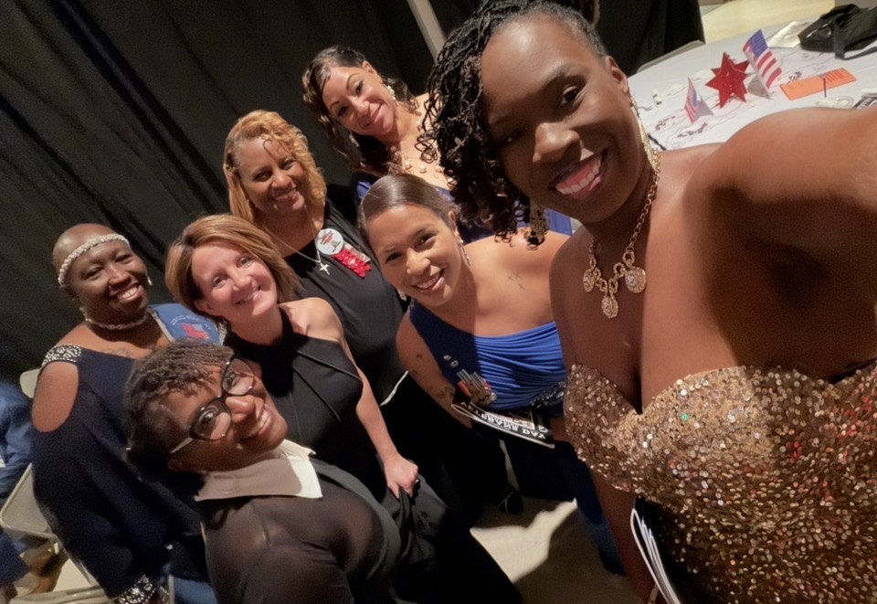 Members enjoying a selfie together at a formal gala