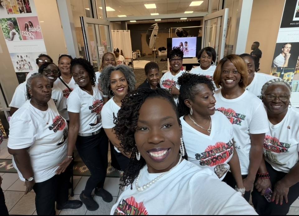 Members in Beauties in Boots tees at a community pop-up