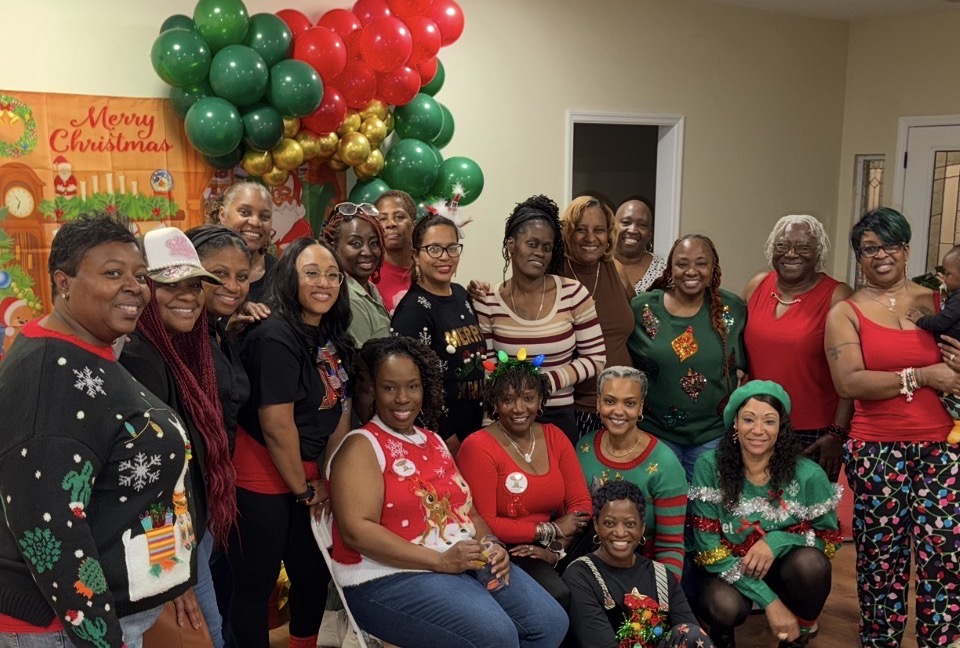 Wide group photo of members at the Merry Christmas celebration