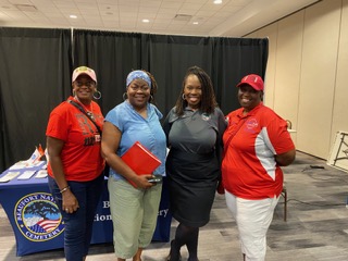 Members at the Navy League information table at a community event
