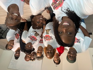 Group selfie of members in matching club tees