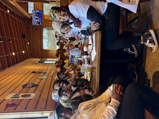 Members sharing a meal together at a local restaurant