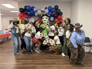 Members posing with the Pirate mascot at a community celebration