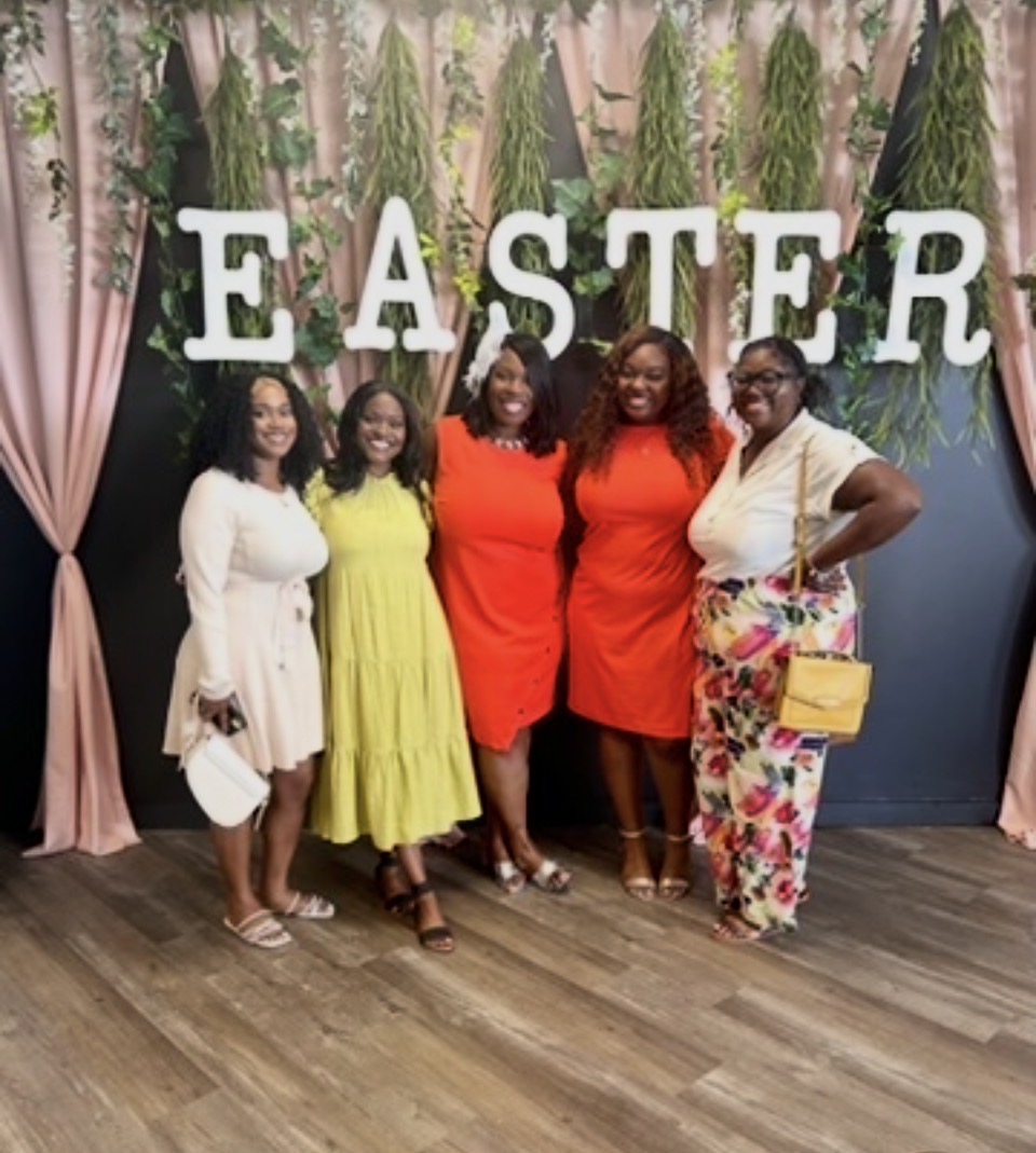 Captain Nathacha Rock with sisters at an Easter celebration