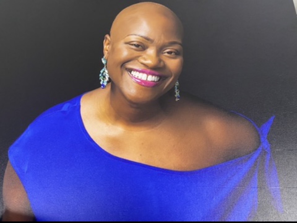 Portrait of Captain Nathacha Rock smiling in blue